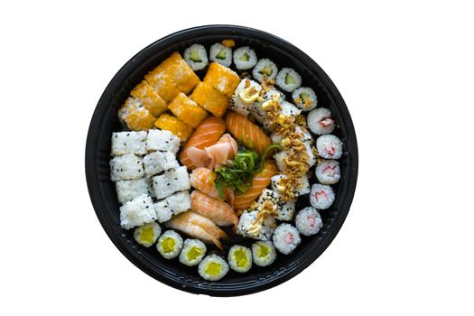 A fresh platter of sushi with rice and fish isolated on wooden table