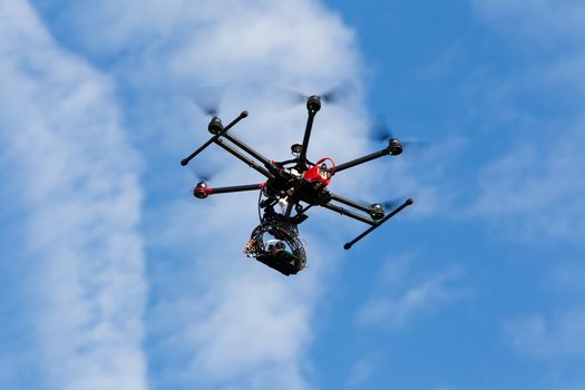 ATHENS, GREECE- DECEMBER 20, 2014: DJI S900 drone in flight with a mounted sony A7  Edition digital camera in Athens, Greece. DJI Industries produces unmanned aircraft for surveillance