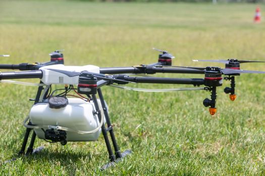 Thessaloniki, Greece - June 21, 2018: Professional agriculture drone on the green field during pre-flight preparation