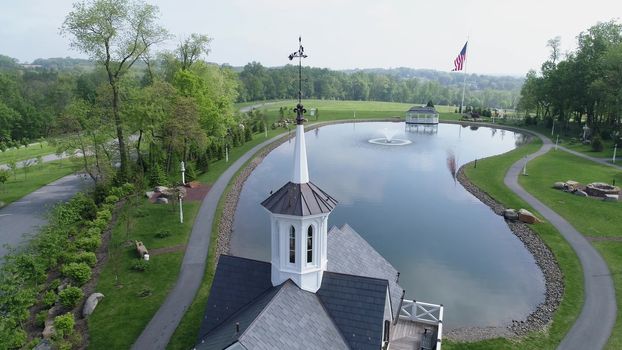 Aerial View of Old Restored Barns by a Pond on a Spring Day