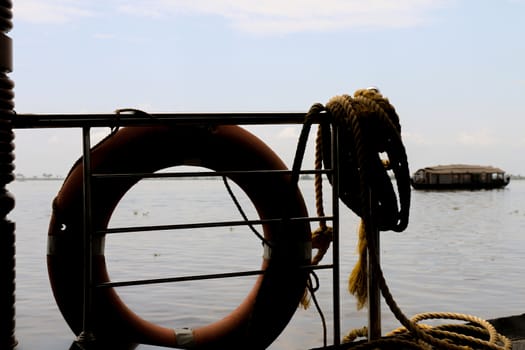 Lifebouy and Rope Silhouette at Dock in a Cloudy day