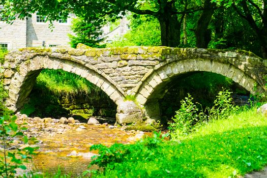 Thirteenth century packhorse bridge and the village of Wycoller.