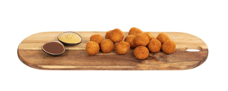 Dutch traditional snack bitterbal on a serving board, isolated