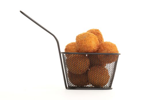 Dutch traditional snack bitterbal in a small basket, isolated