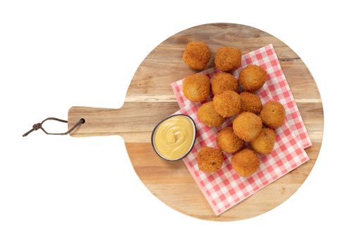 Dutch traditional snack bitterbal on a serving board, isolated