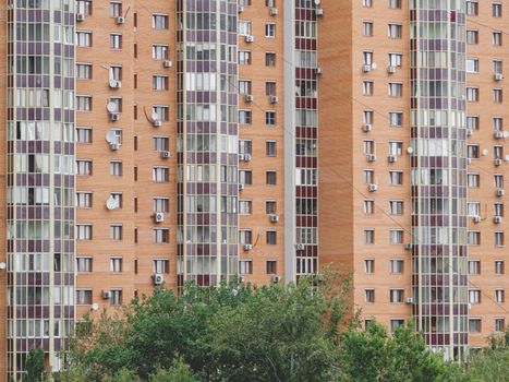 Modern residential apartment building. Lots of air conditioning and satellite plates on the walls of the building.