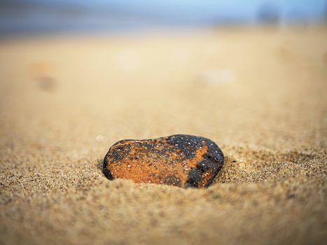 Heart shaped stone on the sand. Valentine day concept