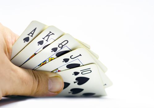 a gambler reveals a royal flush in spades. Gambling and luck. Decisions and risks. Isolated on a white background