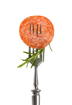 Slice of Hungarian salami and fresh rosemary on fork isolated on white