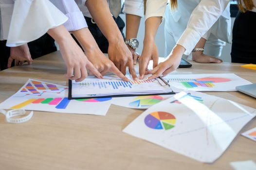 Business people are meeting and graphing business growth on a desk