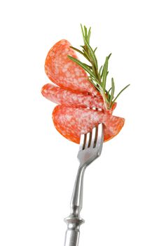 Slices of Hungarian salami and fresh rosemary on fork isolated on white