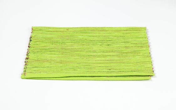 Ribbed green placemat folded in half