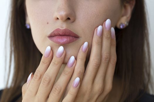 Beautiful woman's nails with beautiful french manicure ombre peach and white