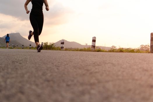 sport woman running on a road. Fitness woman training at sunset