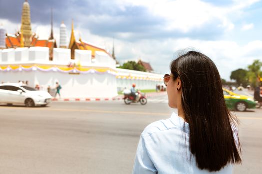 Young Woman traveling to Grand palace and Wat phra keaw at sunset at Bangkok, Thailand