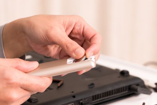 focus on women hand is changing the remote control battery, repair and maintenance