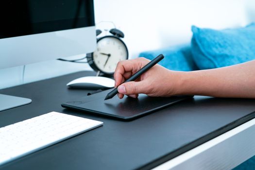 The busy graphic designer working on computer by digital pen mouse