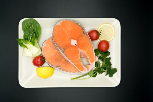 raw salmon steak with vegetable on plate, food and vegetable concept