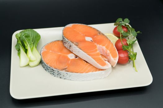 raw salmon steak with vegetable on plate, food and vegetable concept