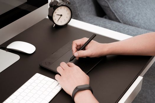 The busy graphic designer working on computer by digital pen mouse, B&W filter