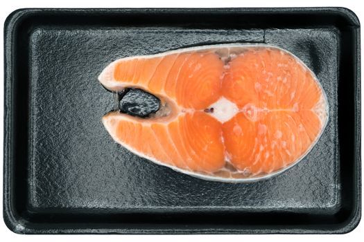isolate raw salmon steak on the black packaging foam