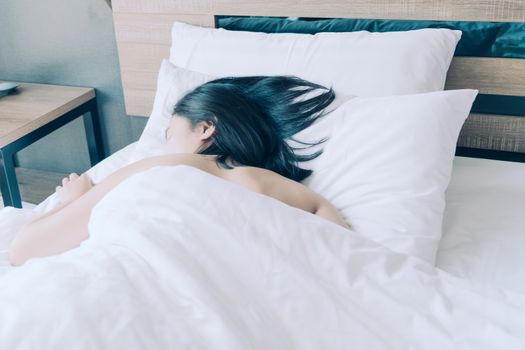 women sleep in white pillow on bed