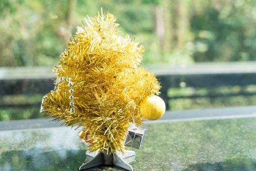 mini golden Christmas tree with hanging of small present