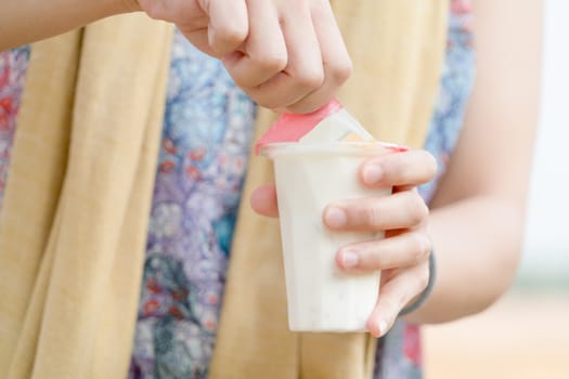 women hand opening  the fruit salad soy milk jelly, yogurt, dessert, healthy, sweet, yummy