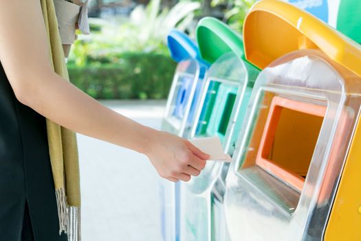 women hand throwing away the garbage to the bin/trash, sorting waste/garbage before drop to the bin