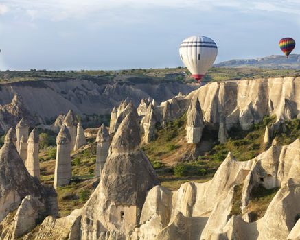 A view of the colored balloons flying over the Valley of Love at dawn. Cappadocia, Turkey.