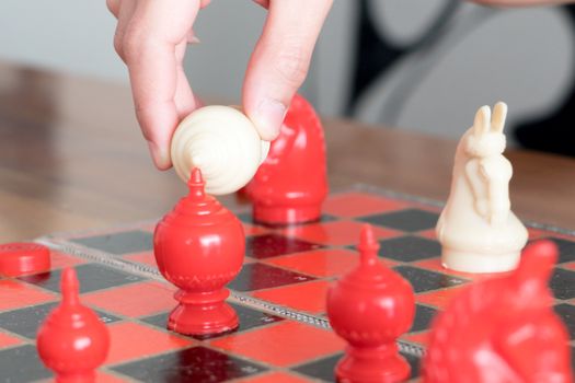 the white chess on women hand is fighting with red