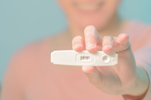 focus on the positive pregnancy test result hold on happy women hand