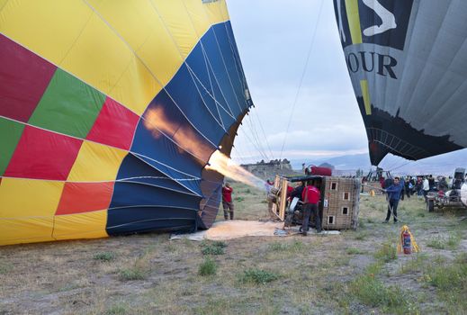 05.13.2018. Cappadocia, Goreme, Turkey. People inflate balloons with a gas burner of high power.