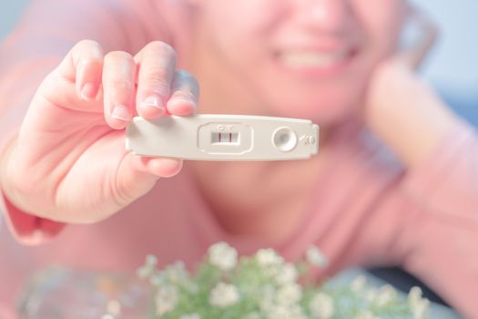 focus on the positive pregnancy test result hold on happy women hand