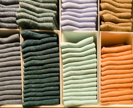 colorful socks stack on shelves for sale in clothing store