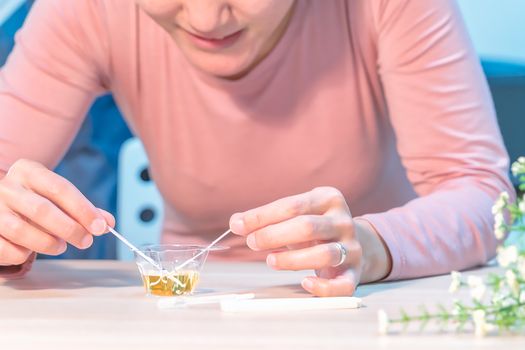 the happy women hand put the pregnancy test pad to the urine and waiting for the result