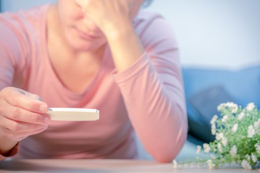 soft focus on sad women hand hold the pregnant test pad after saw the negative  test result