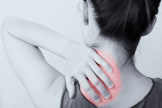 closeup women neck and shoulder pain/injury with red highlights on pain area with white backgrounds, healthcare and medical concept - B&W filter