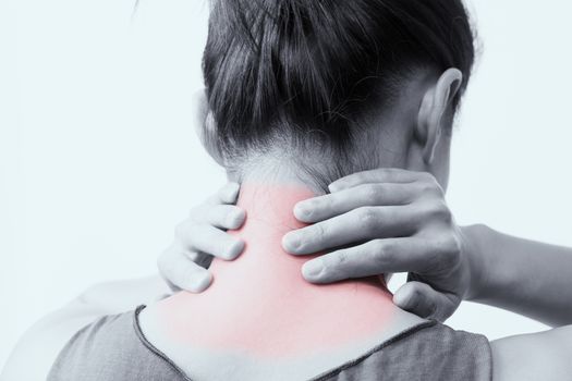 closeup women neck and shoulder pain/injury with red highlights on pain area with white backgrounds, healthcare and medical concept - B&W filter
