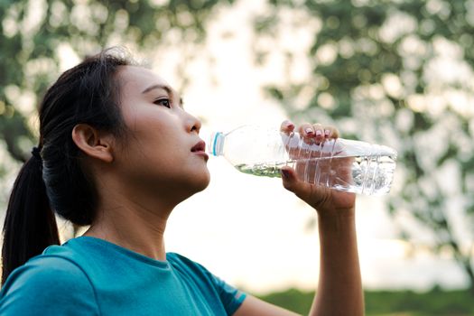 Fitness Asia Woman Drinking Water after Running