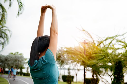 fitness woman runner stretching arm before run. Outdoor exercise activities concept