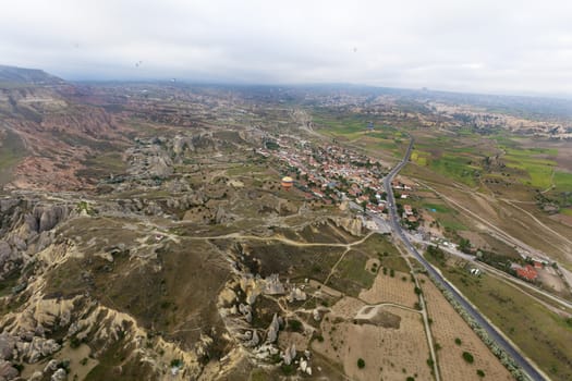 View of dozens of balloons flying over the valleys of Cappadocia at dawn in central Turkey.