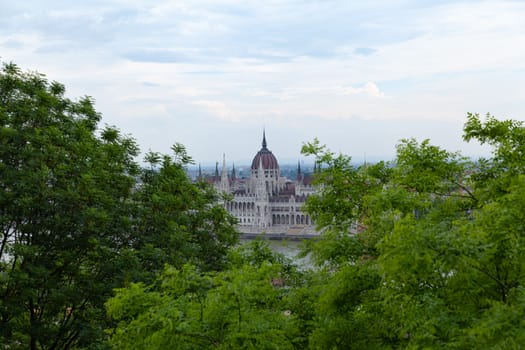 Budapest, Hungary - 7 May 2017: Hungarian Parliament framed by trees