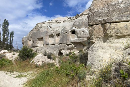 Abandoned caves in the Cappadocia mountains against the blue sky