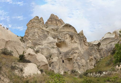 Abandoned caves in the Cappadocia mountains against the blue sky