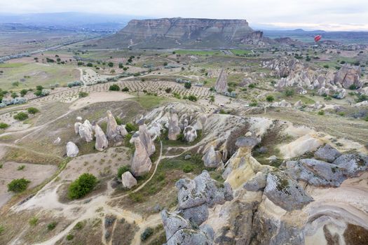 The mountains of Cappadocia impress with their nakedness and openness. Balloons rise above them.