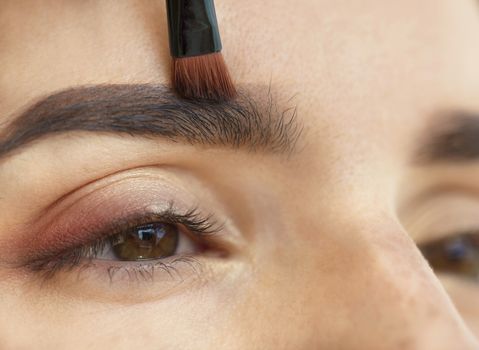 Makeup eyebrows close-up with a soft brush.