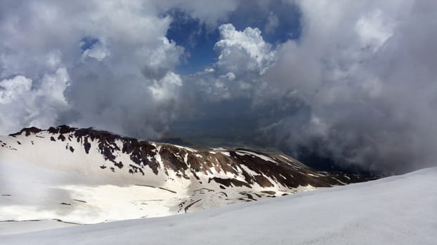 The morning sun illuminates the mountain landscape in places covered with snow