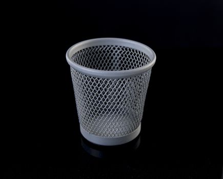 metal pen tray or trash can for the desk on black background