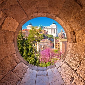 Rome. Scenic springtime view through stone window over the ruins of the Roman Forum in Rome, capital of Italy